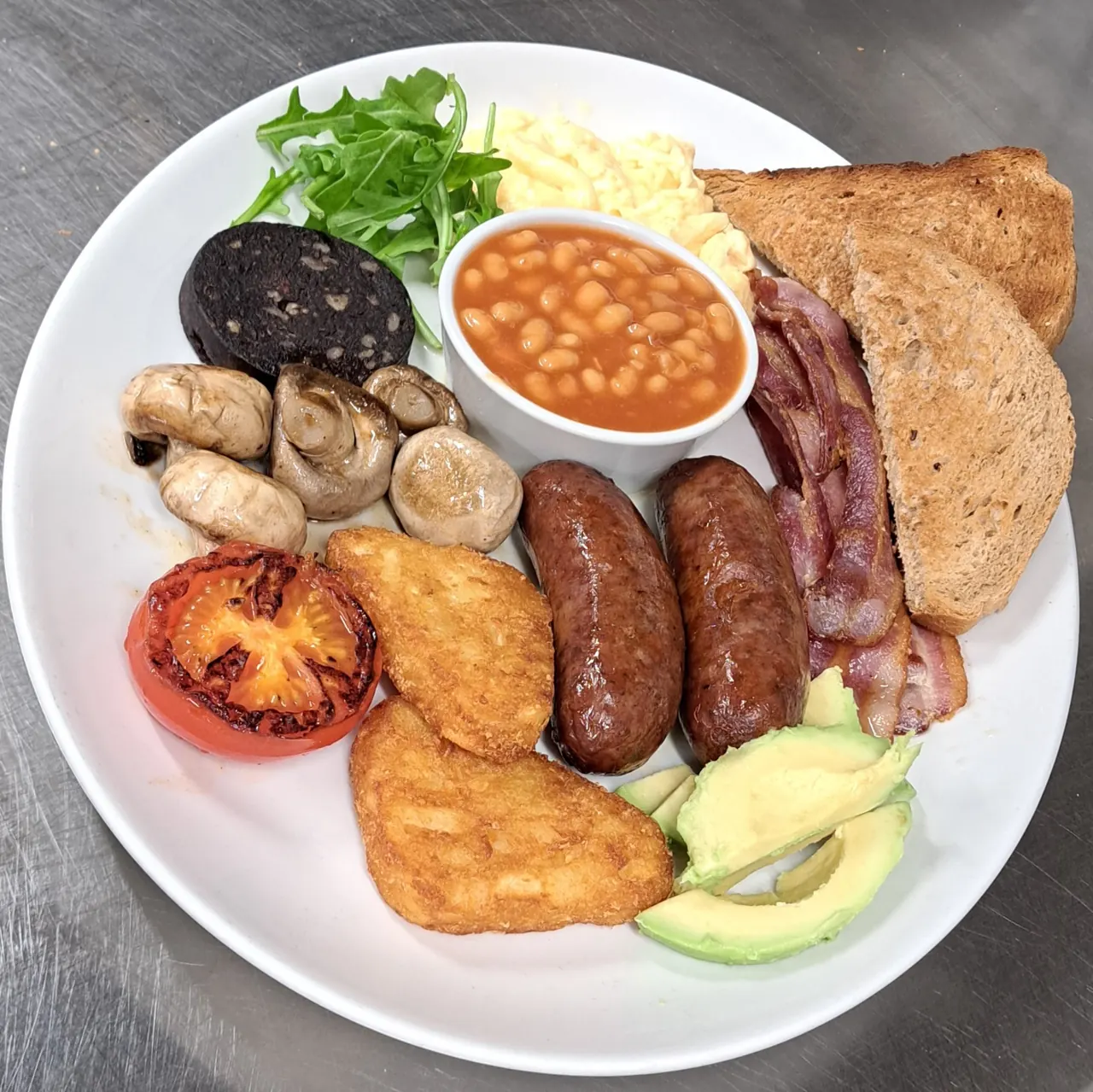 Full English breakfast with sausages, bacon, beans, black pudding and toast
